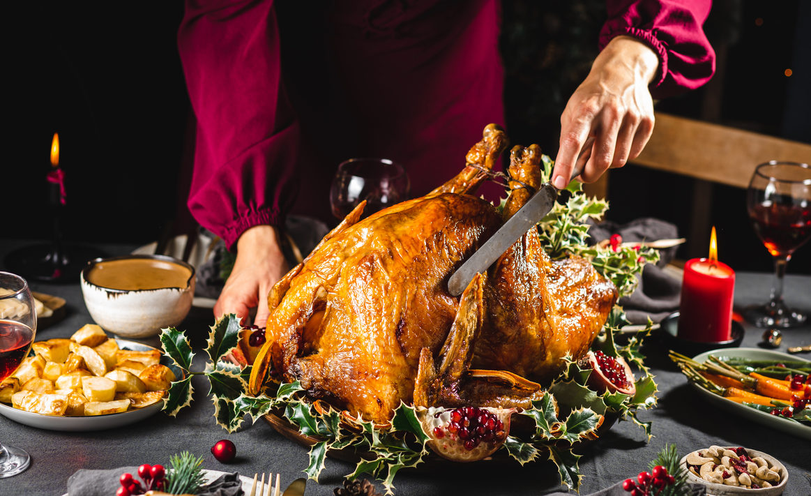 Carving turkey for family's Christmas dinner